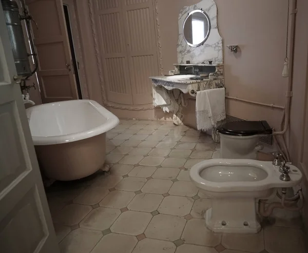 vintage, aged Bathroom interior. Tile bathroom with a round mirror. Nobody inside