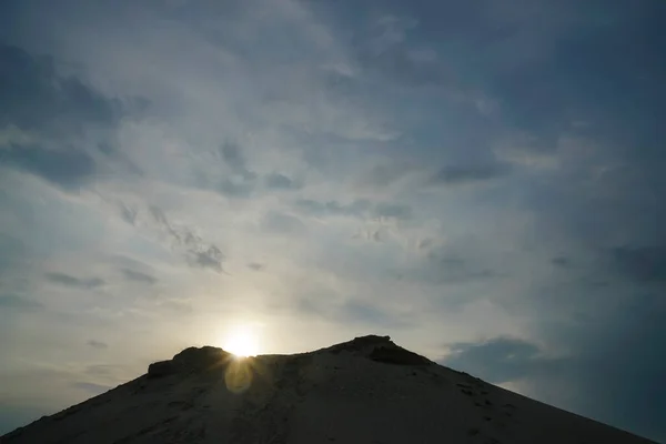 Sunset in the desert. down above sandy mountain. horizon line