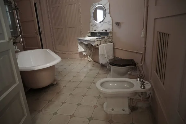 vintage, aged Bathroom interior. Tile bathroom with a round mirror. Nobody inside