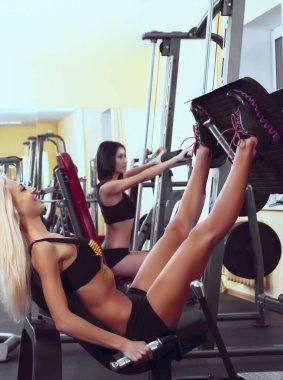 Genç yetişkin kızların portresi spor salonunda egzersiz yapıyor. 
