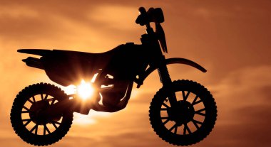 Çapraz dayanıklı motosiklet silueti gün batımında arka planda havada zıplıyor.