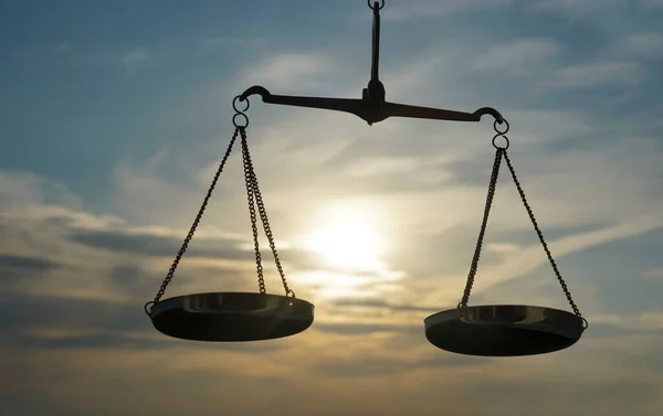 Scales of Justice background - legal law concept. a balance is hand-held, sky is the background.zodiac sign - libra