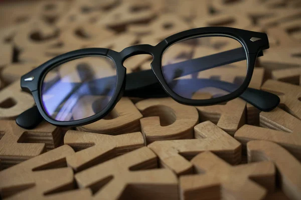 Black Stylish Glasses Lie Wooden Letters Test Chart — Stock Photo, Image