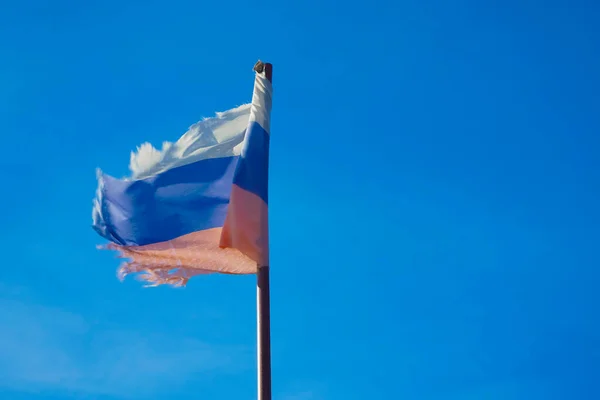 旧俄罗斯国旗挂在生锈的旗子上 俄罗斯国旗挂在蓝天上 俄罗斯国旗的白色 蓝色和红色三色旗在蓝天的映衬下 — 图库照片
