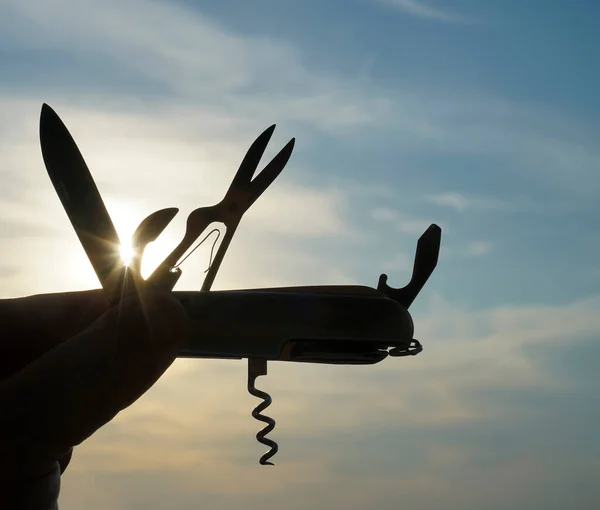 Silhouette Hand Holding Folding Multifunction Knife Backlight Sunset — Stock Photo, Image