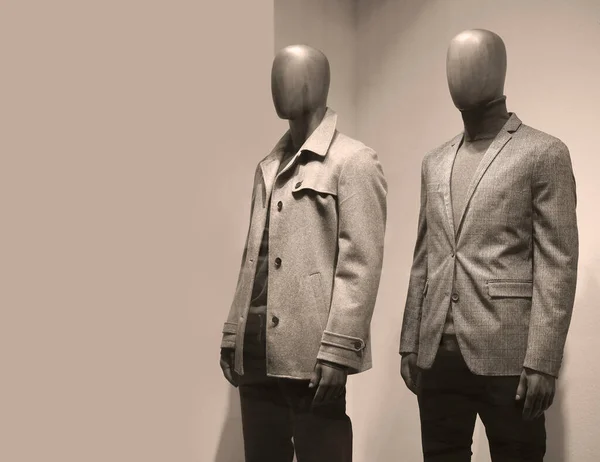Manikins in european fashion store. Two mannequins wear luxury style winter clothes.
