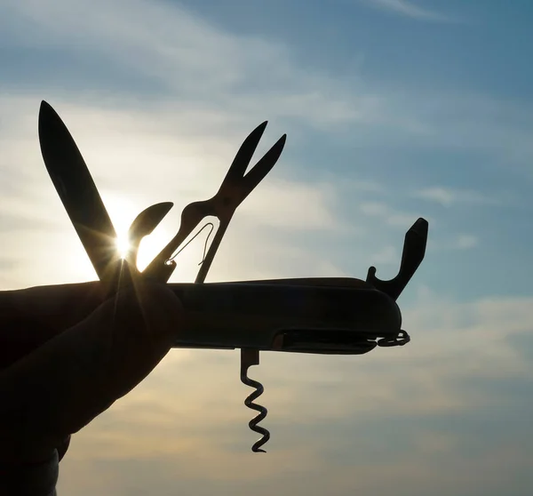 Silhouette Hand Holding Folding Multifunction Knife Backlight Sunset — Stock Photo, Image
