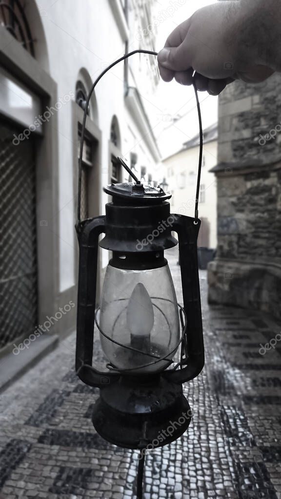 Old kerosene lantern on european street background. Retro style.  Can be used as a background image to copy space. Czech republic, Prague.