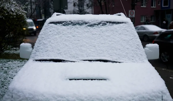 寒い車は冬の日に雪をカバーし フロントウィンドウのフロントガラスと雪の背景にフードを表示します 雪の後の朝 — ストック写真