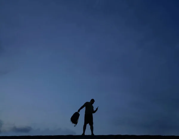 Silhouette Man Using Mobile Phone Hold Hand Backpack — Stock Photo, Image