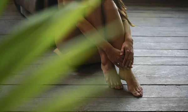 Female feet on a wooden floor. naked woman. no face.