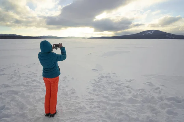 Uma Rapariga Fotografa Telefone Lago Congelado Visão Traseira — Fotografia de Stock