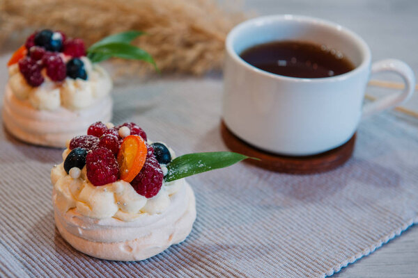 Pavlova meringue cake with cream and small fruits