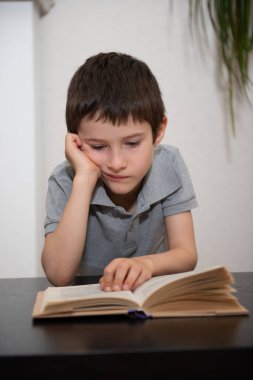 İlgisiz bir öğrenci kitap okur.