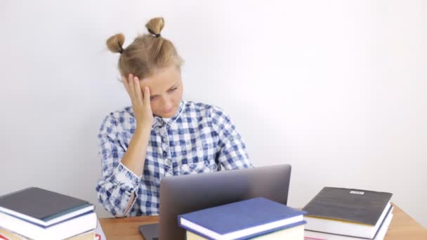 Female student prepares for the exam and rubs her eyes — Stock Video