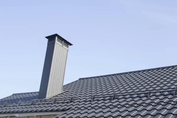 Roof with a chimney is made of ferrous metal — Stock Photo, Image