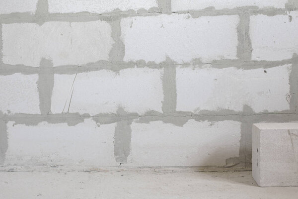 The wall is built of large white blocks. Construction