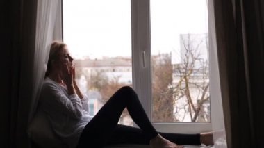 Girl with a headache is sitting
