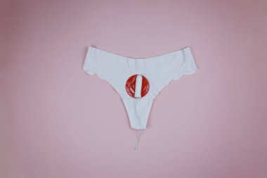 White panties and tampon indicating the arrival of menstruation