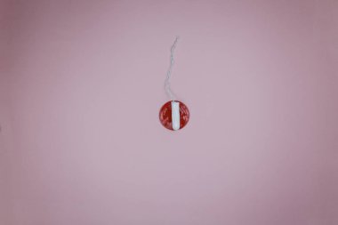 Womens tampon with a red alarm. Concept of hygiene
