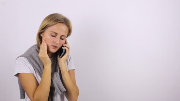 Młoda kobieta dzwoni po karetkę przez telefon komórkowy. Choroba i ogólne złe samopoczucie — Wideo stockowe