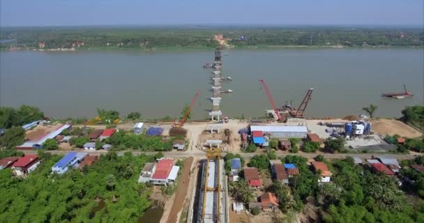 Aerial Drone Shot Fly Back Revealing Construction Bridge Starting Riverbank — Stock Video