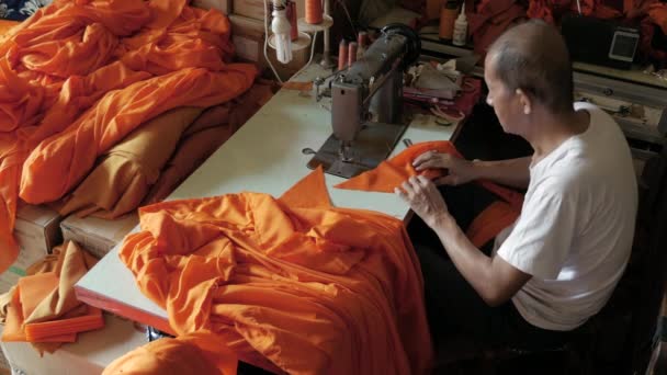 Old Man Making Orange Robe Monk Using Sewing Machine — Stock Video
