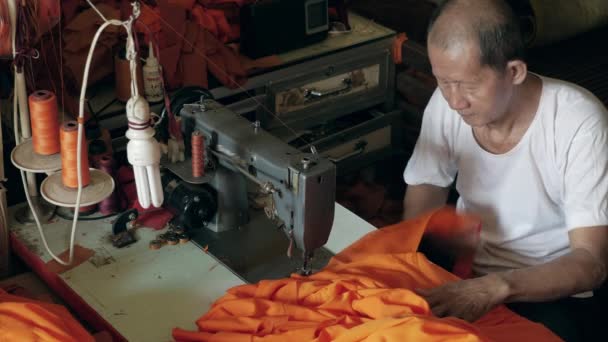 Old Man Making Orange Robe Monk Using Sewing Machine — Stock Video