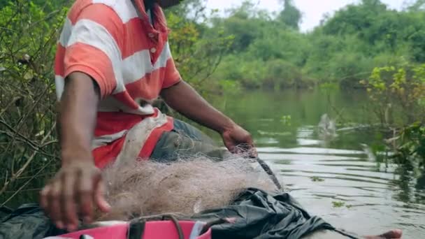 Fisherman Bow His Dugout Canoe Disengaging Water Snake His Net — Stock Video