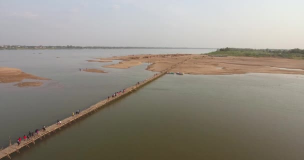 Aerial Drone Shot Fly People Crossing Bamboo Bridge River Straw — Stock Video