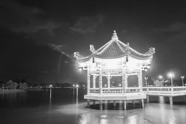 Chinese ancient pavilion on the pond at night in Udon Thani,Thailand. Black and white image style.