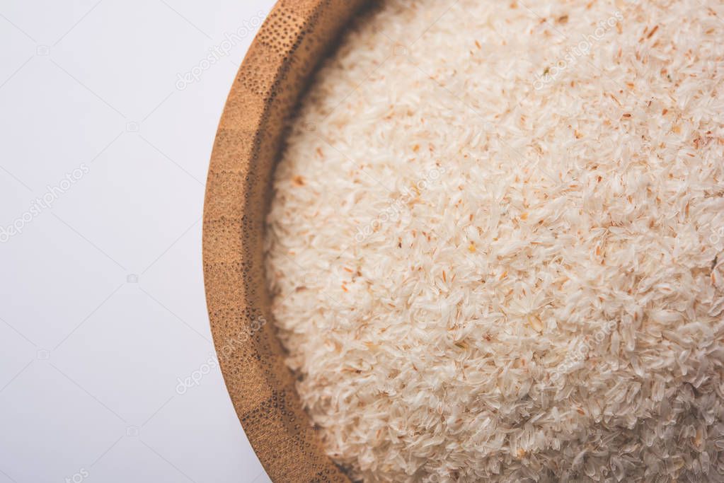 Psyllium husk or isabgol which is fiber derived from the seeds of Plantago ovata, mainly found in India. Served in a bowl over moody background. selective focus