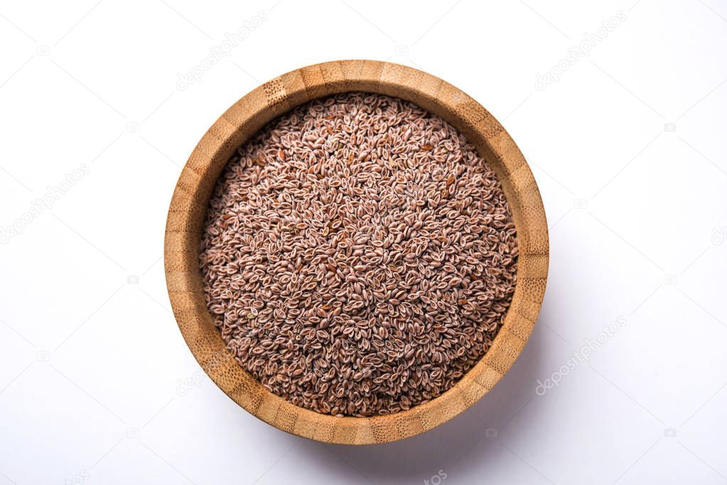 Psyllium husk or isabgol which is fiber derived from the seeds of Plantago ovata, mainly found in India. Served in a bowl over moody background. selective focus