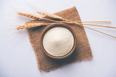 Ham İrmik unu veya Rava toz makarnalık buğday kaba, saflaştırılmış buğday yonca olduğunu. Düz arka plan üzerinde bir yığın olarak veya bir kase ya da kaşık servis. Seçici odak