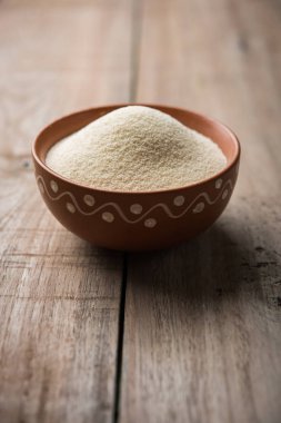 Ham İrmik unu veya Rava toz makarnalık buğday kaba, saflaştırılmış buğday yonca olduğunu. Düz arka plan üzerinde bir yığın olarak veya bir kase ya da kaşık servis. Seçici odak