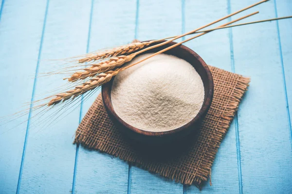 Ham İrmik unu veya Rava toz makarnalık buğday kaba, saflaştırılmış buğday yonca olduğunu. Düz arka plan üzerinde bir yığın olarak veya bir kase ya da kaşık servis. Seçici odak