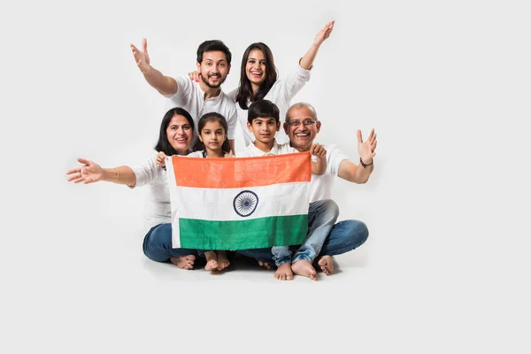Happy Indian Family Holding National Tricolour Flag While Sitting Isolated — Stock Photo, Image