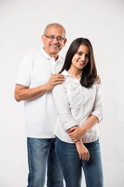 old Indian father with young daughter standing isolated over white background
