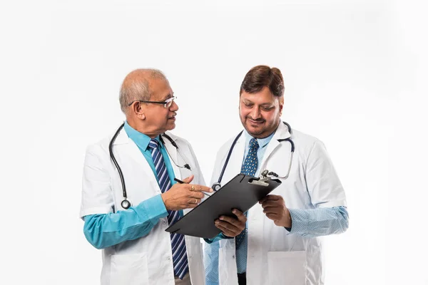 Two Indian Male Doctors Discussing Medical Case Chart Standing Isolated — Stock Photo, Image