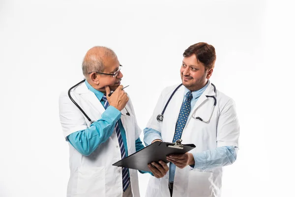 Two Indian Male Doctors Discussing Medical Case Chart Standing Isolated — Stock Photo, Image