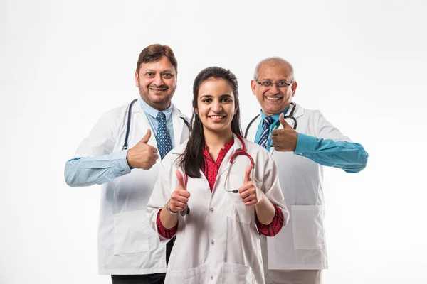 Group of Indian medical doctors, male and female standing isolated on white background, selective focus