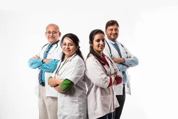 Group of Indian medical doctors, male and female standing isolated on white background, selective focus