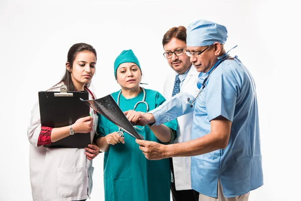 Indian doctors looking an x-ray or MRI isolated over white background. Selective focus