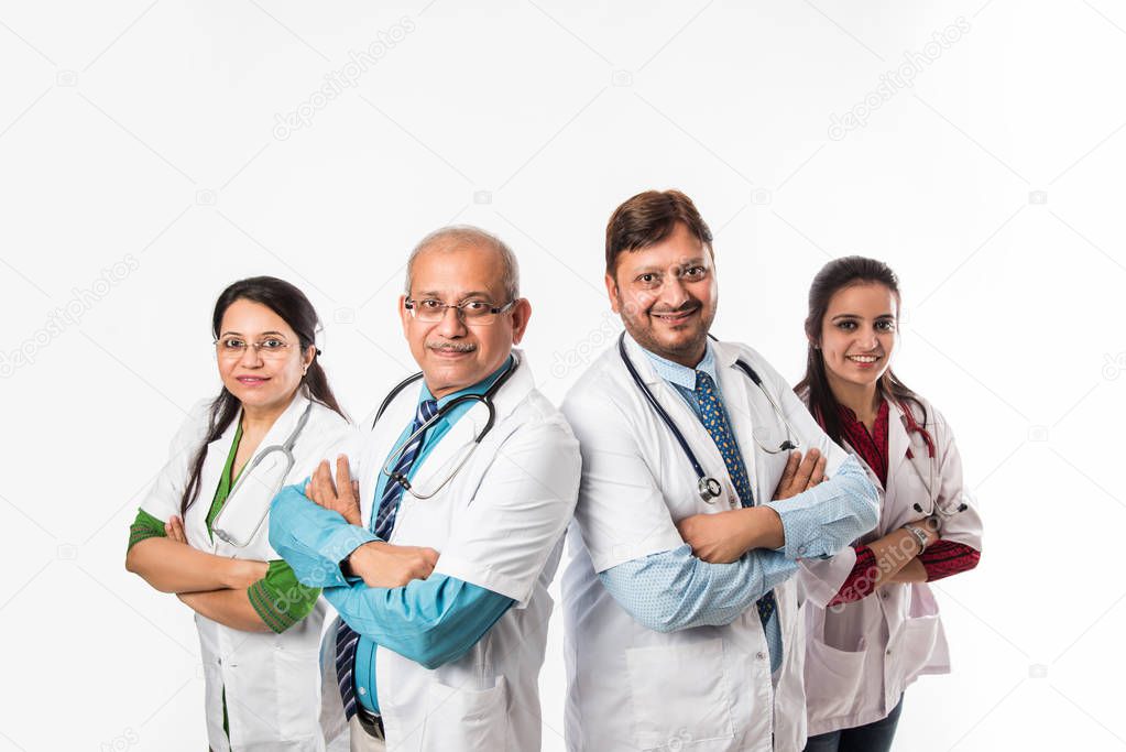 Group of Indian medical doctors, male and female standing isolated on white background, selective focus