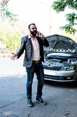 Araç / araba arızalı endişeli Hintli işadamı, telefonda konuşuyor.