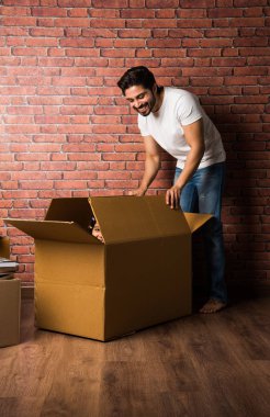 Hint Baba, karton kutunun içinde kızının yanında poz veriyor, taşınıyor ya da paketleri açıyor.