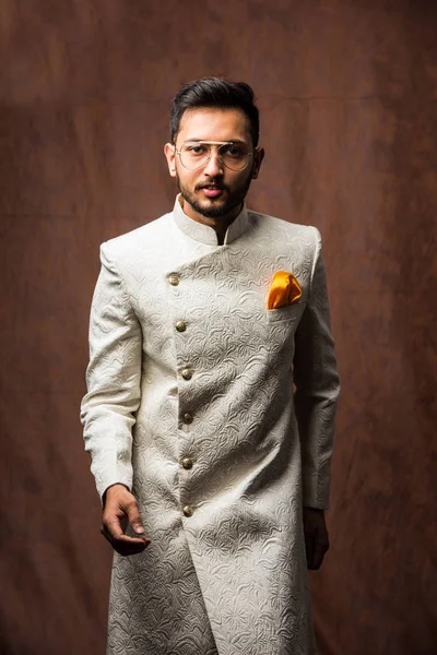 インドの伝統的な服の男またはKurta Pyjamaの服 シャーワニの男性ファッションモデル 茶色のグランジの背景に対するポーズ 選択的フォーカス — ストック写真
