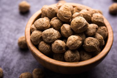 Çiğ Soya Parçacıkları, vejetaryenler için soya eti renkli arka planda bir kasede ya da yığın halinde izole edilmiş.