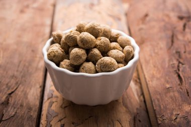 Çiğ Soya Parçacıkları, vejetaryenler için soya eti renkli arka planda bir kasede ya da yığın halinde izole edilmiş.