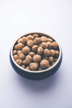 Çiğ Soya Parçacıkları, vejetaryenler için soya eti renkli arka planda bir kasede ya da yığın halinde izole edilmiş.